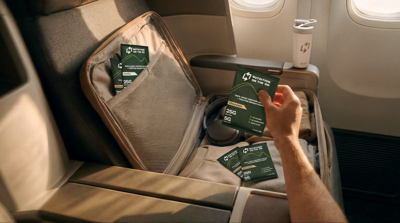 Person holding a nutrition on the go packet on an airplane