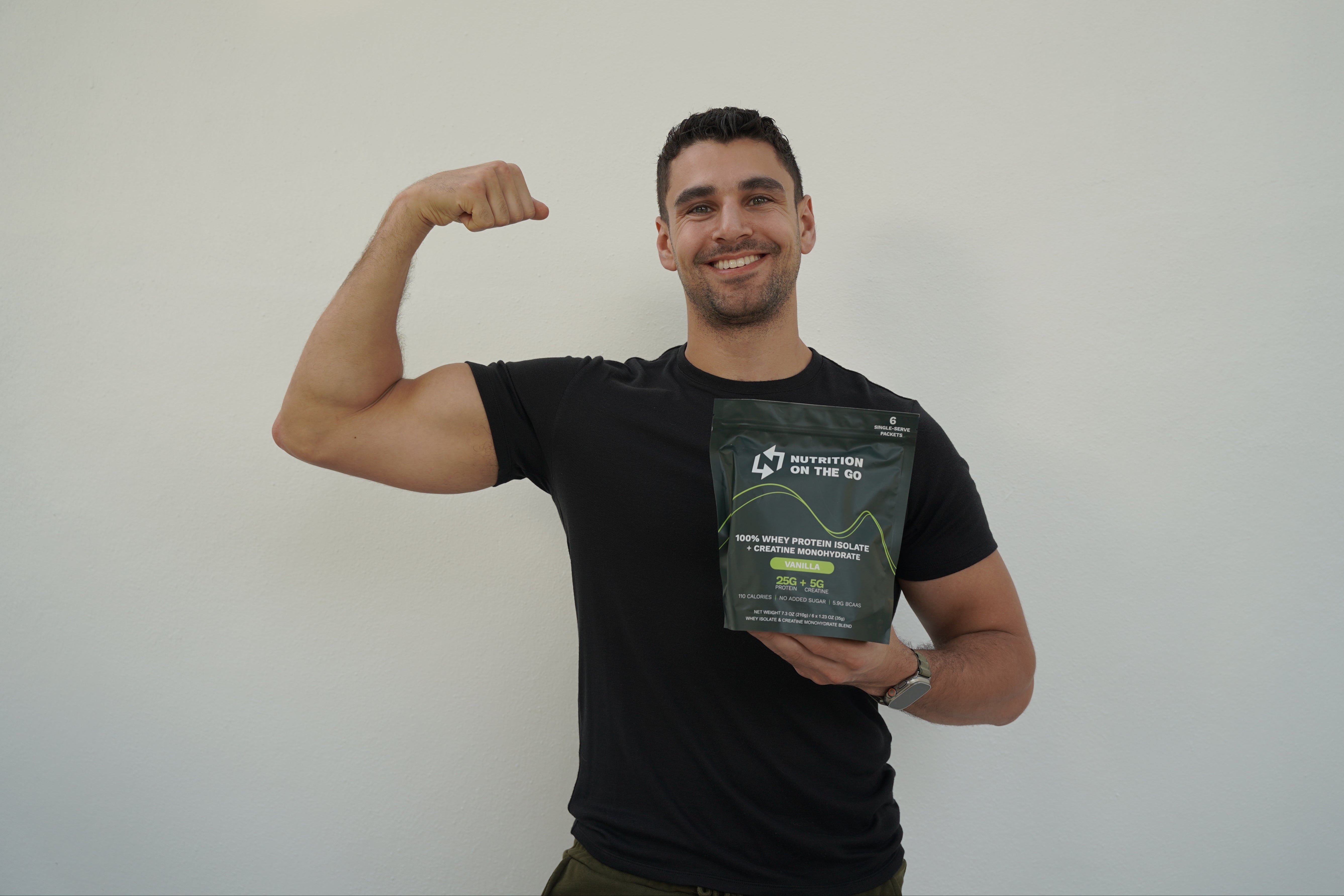 Gabe The Founder Flexing With a bag of nutrition on the go