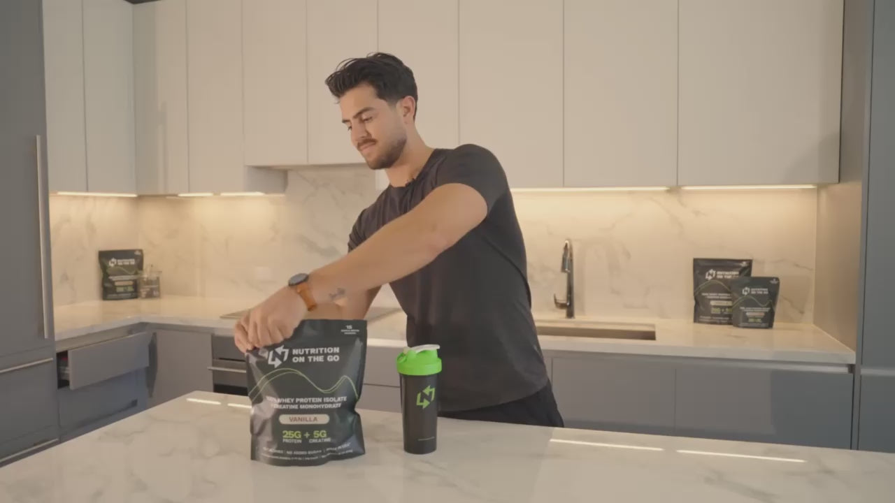 man opening nutrition on the go package, grabbing a packet and making a protein shake